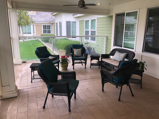 A cozy outdoor seating area with comfortable chairs and a coffee table, perfect for enjoying the fresh air.