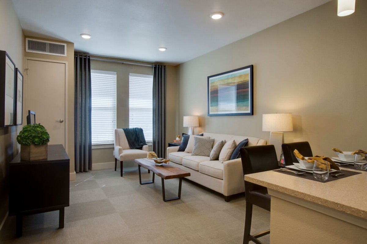 A cozy living room with a comfortable sofa, coffee table, and ambient lighting.