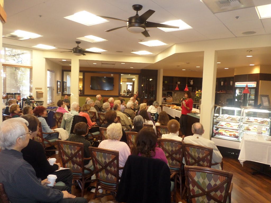 A small group of people seated in a room, attentively listening to a presentation.