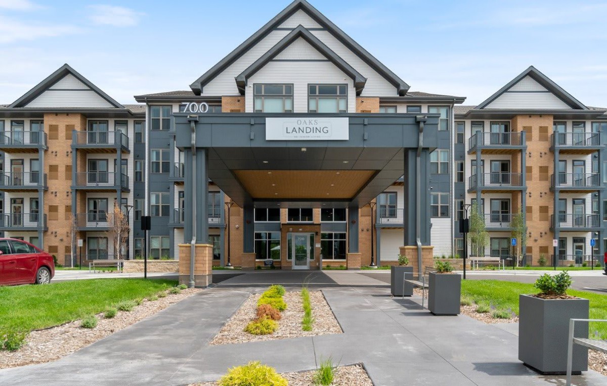 Modern residential building entrance with landscaped pathway.