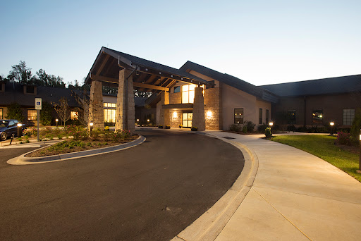 A welcoming entrance to a modern building, illuminated during the evening.