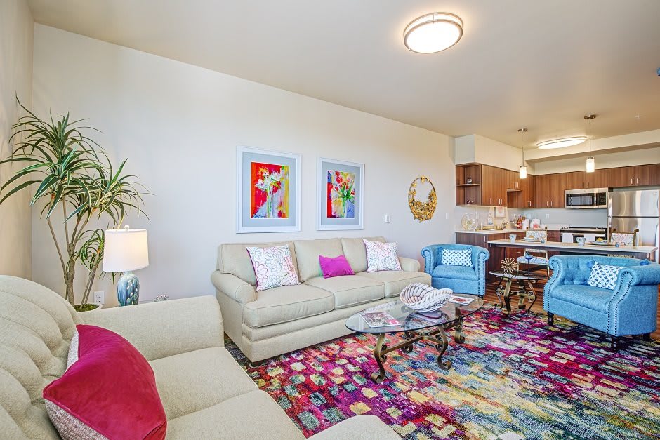 A vibrant living room with modern furniture, colorful accents, and open layout.