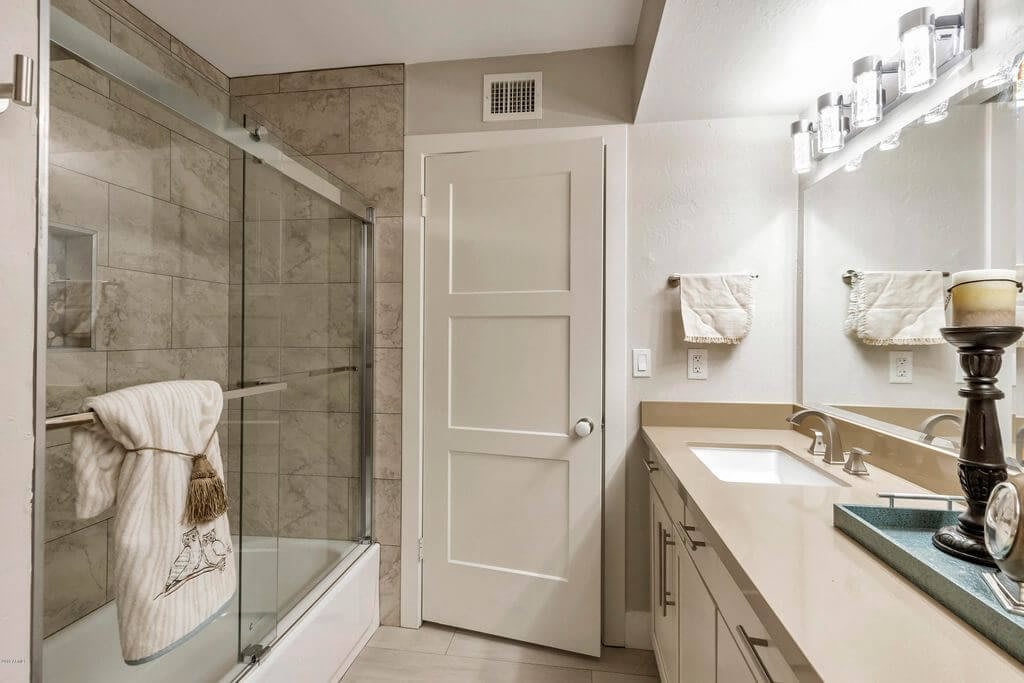 A modern bathroom with a glass-enclosed shower and elegant fixtures.