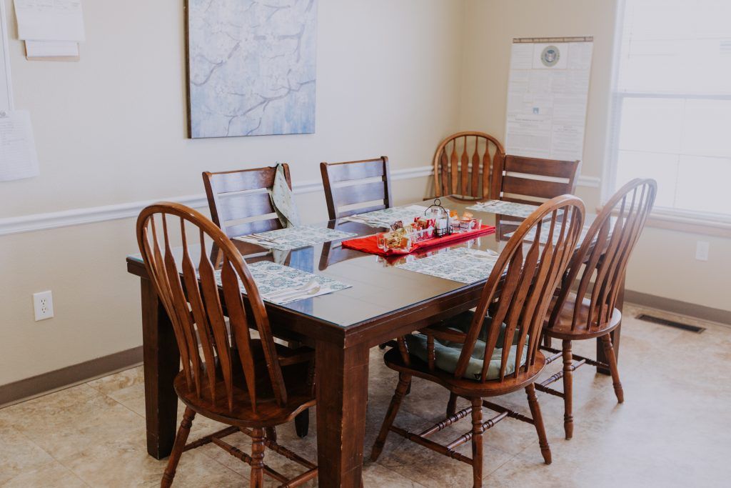 A cozy dining area with a wooden table set for a meal.