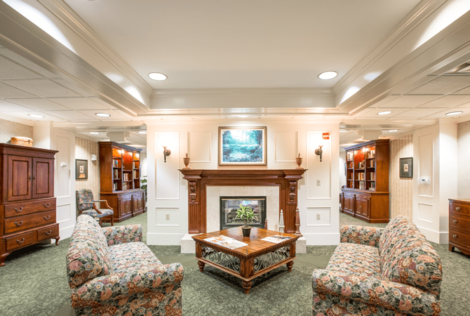 A cozy and elegantly decorated living room featuring a fireplace and comfortable seating.