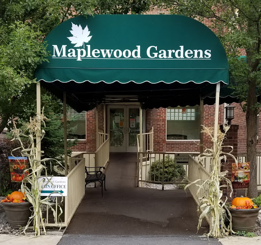 The welcoming entrance of Maplewood Gardens, adorned with autumn decorations.
