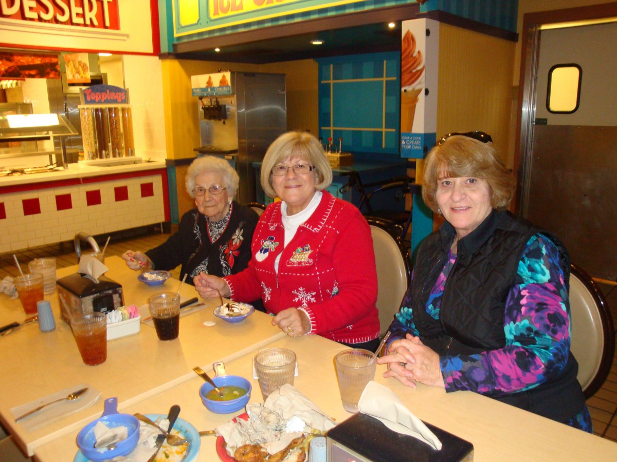 A group of three women enjoying a meal together at a restaurant.
