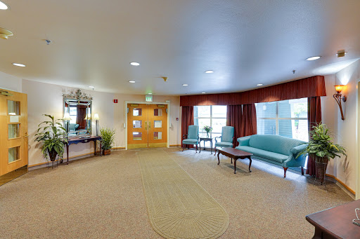 A spacious and welcoming lounge area featuring comfortable seating and warm lighting.