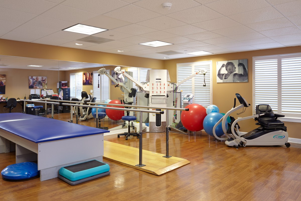 A well-equipped physical therapy and rehabilitation facility with exercise equipment and therapy tools.
