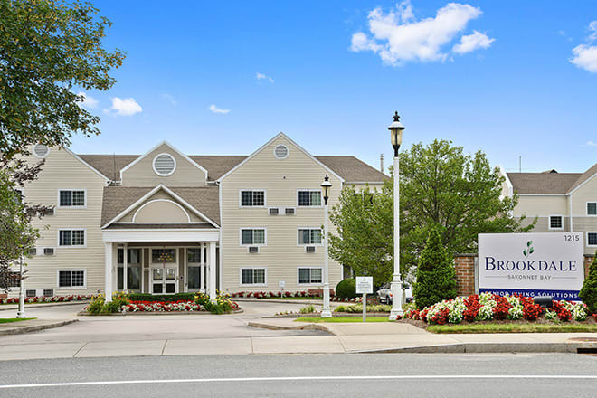 Front view of a hotel with a welcoming entrance and landscaped surroundings.