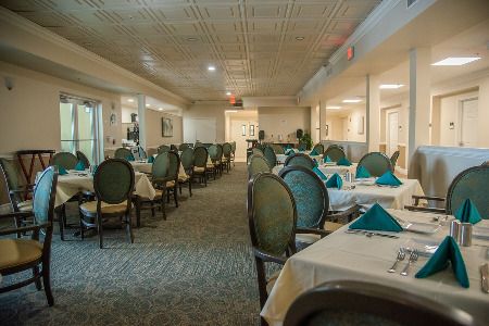 An elegant restaurant dining area with neatly arranged tables and chairs.