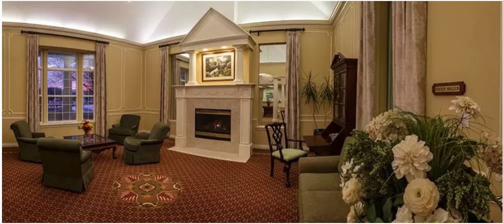 A cozy living room with a fireplace, elegant furniture, and decorative elements.
