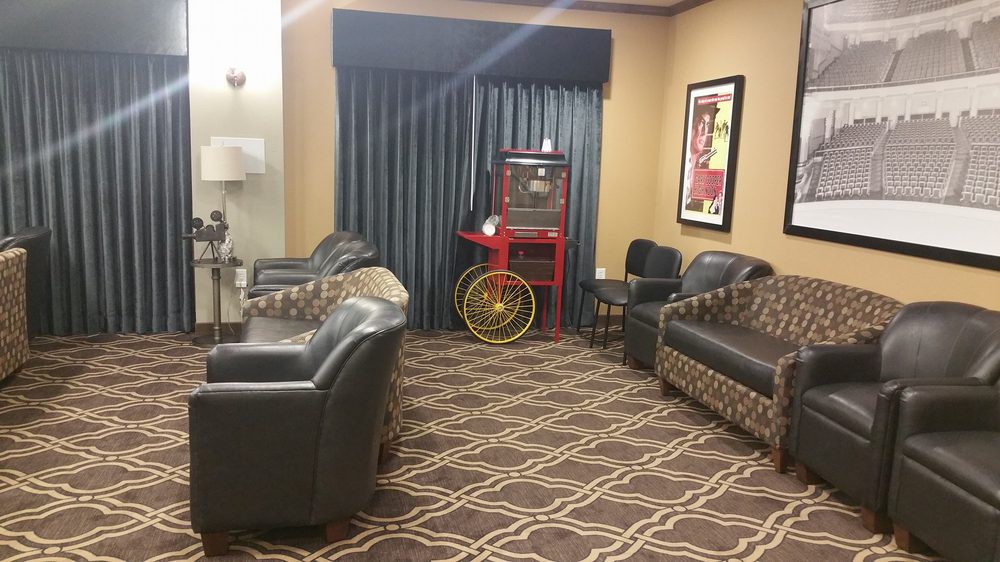 A cozy lobby with leather seating and a vintage popcorn machine.