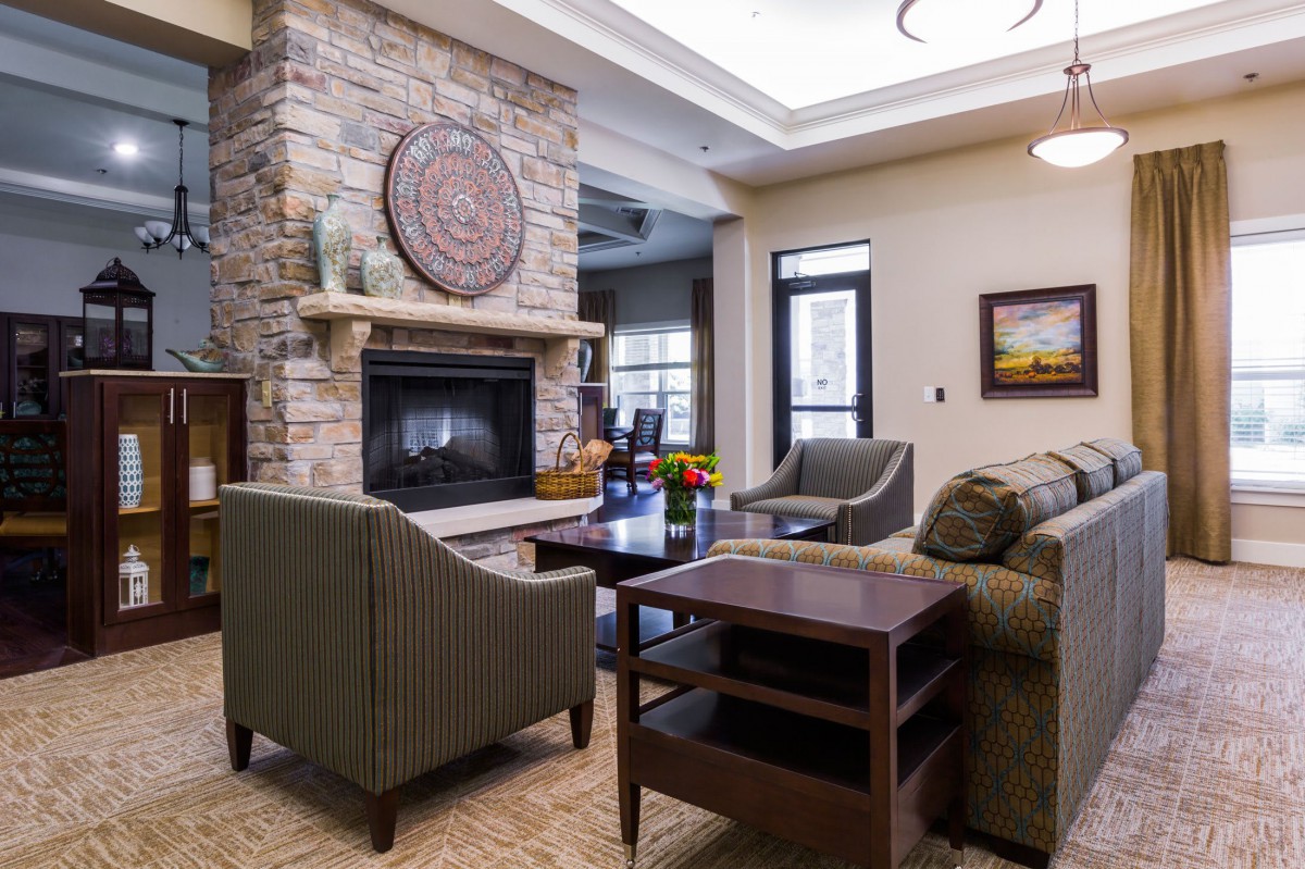 A modern living room with a cozy fireplace and comfortable seating.