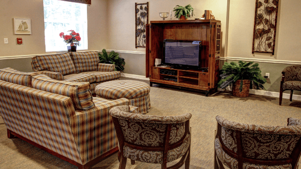 A cozy living room with a television and comfortable seating.