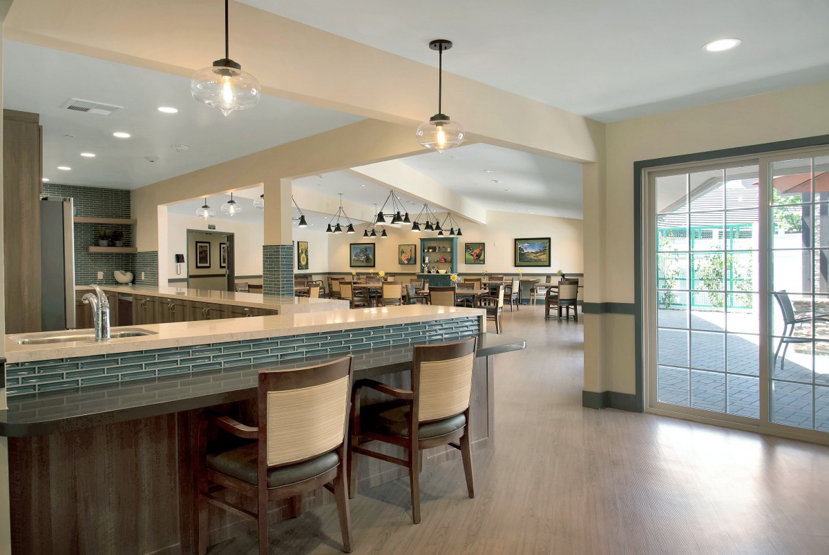A modern dining area with bar seating and elegant lighting.