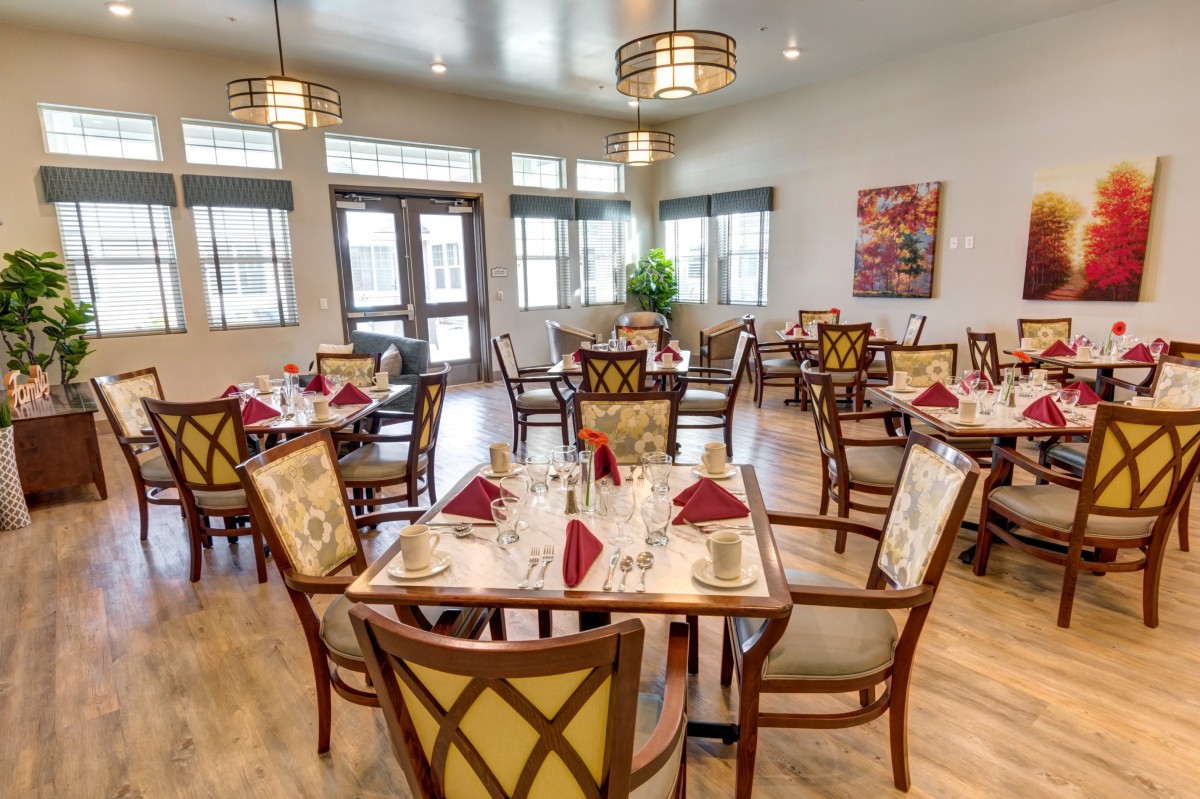 A well-arranged dining room with neatly set tables and elegant decor.