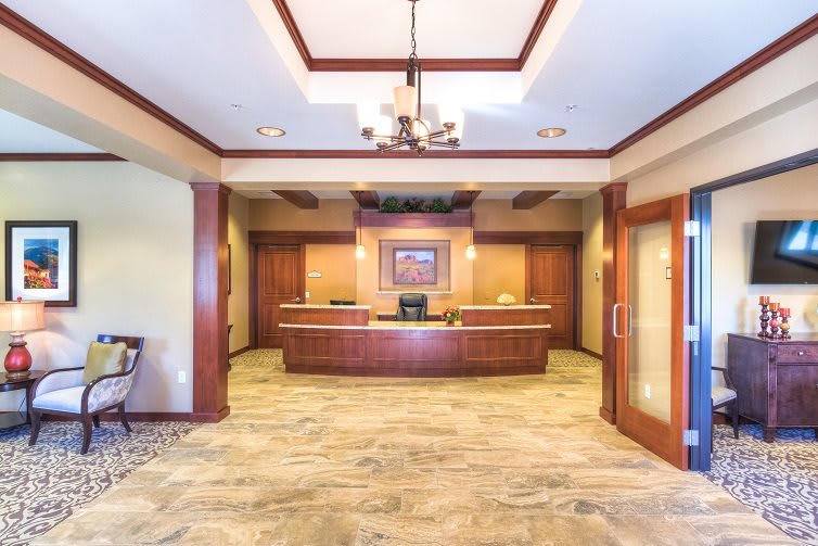 A spacious lobby area with a reception desk and elegant interior design.