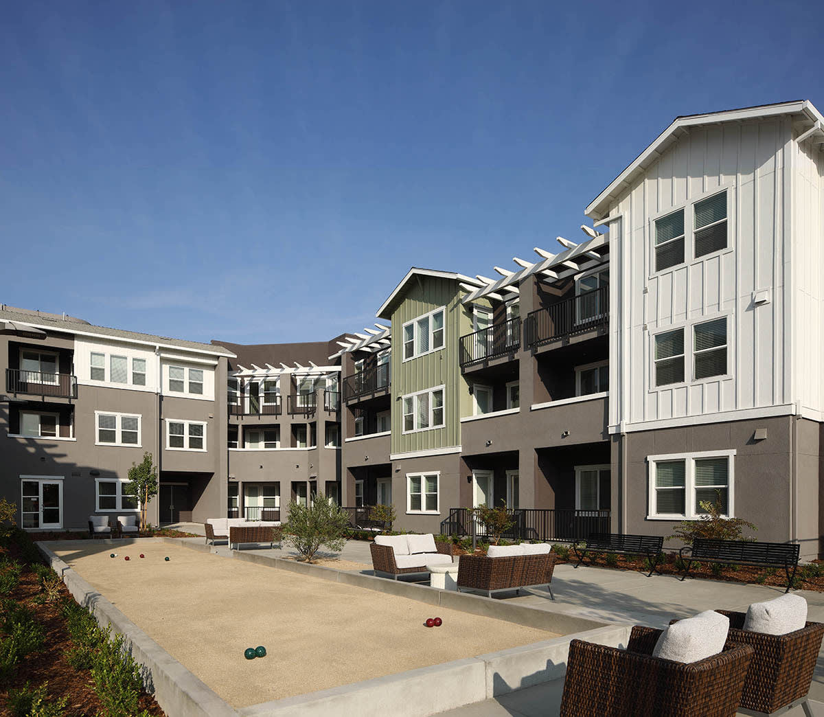 Modern apartment complex with outdoor seating area.
