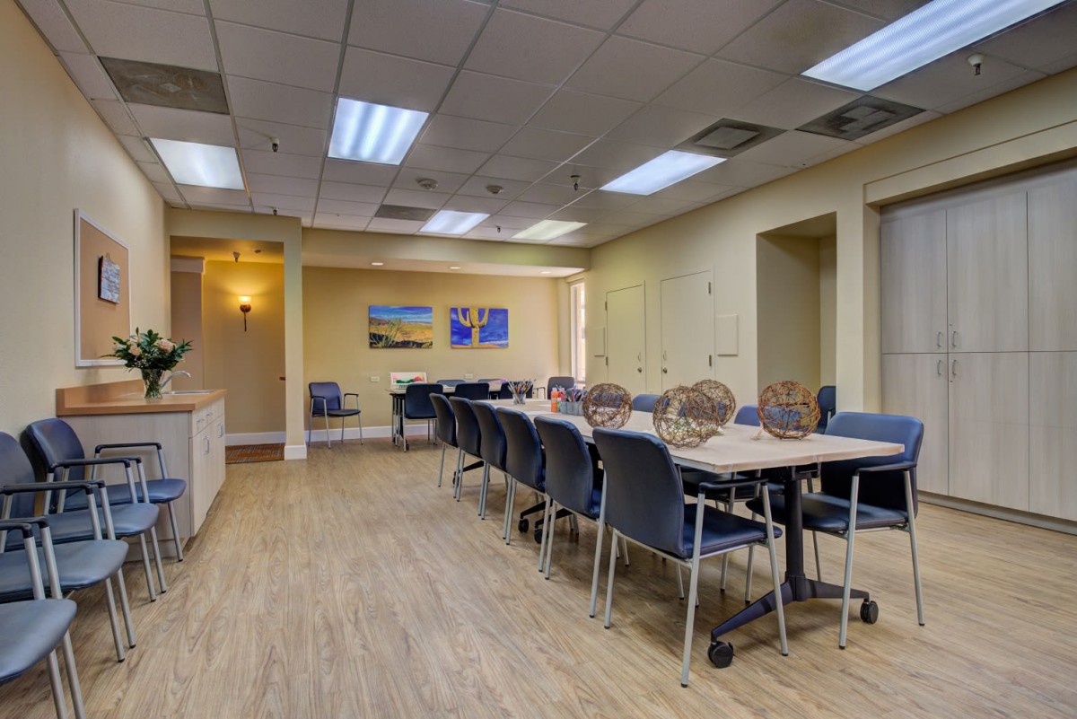 A modern conference room with tables and chairs arranged for meetings.