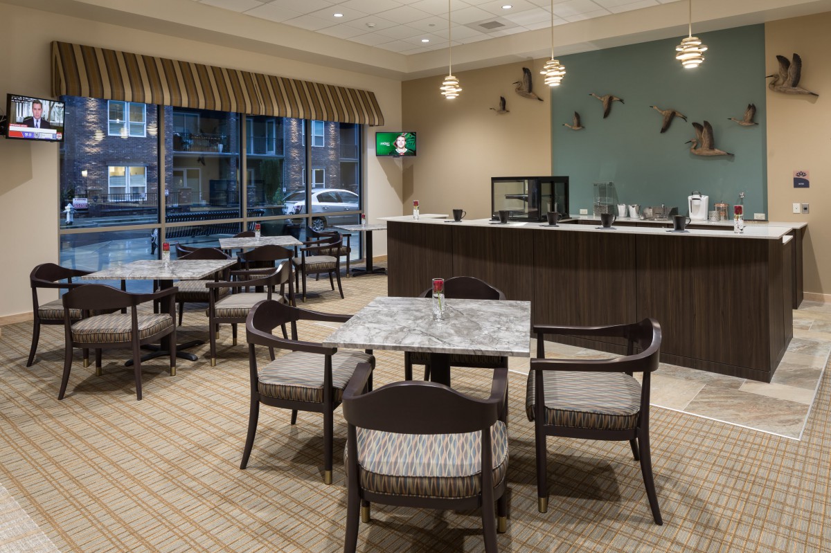Modern cafe interior with seating area and beverage counter.