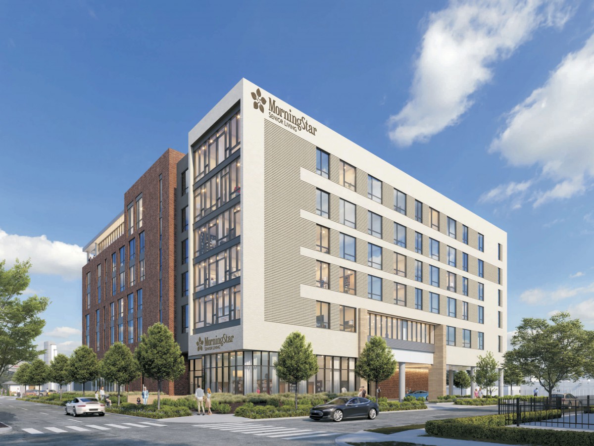 A modern hotel building with a sleek architectural design under a clear blue sky.