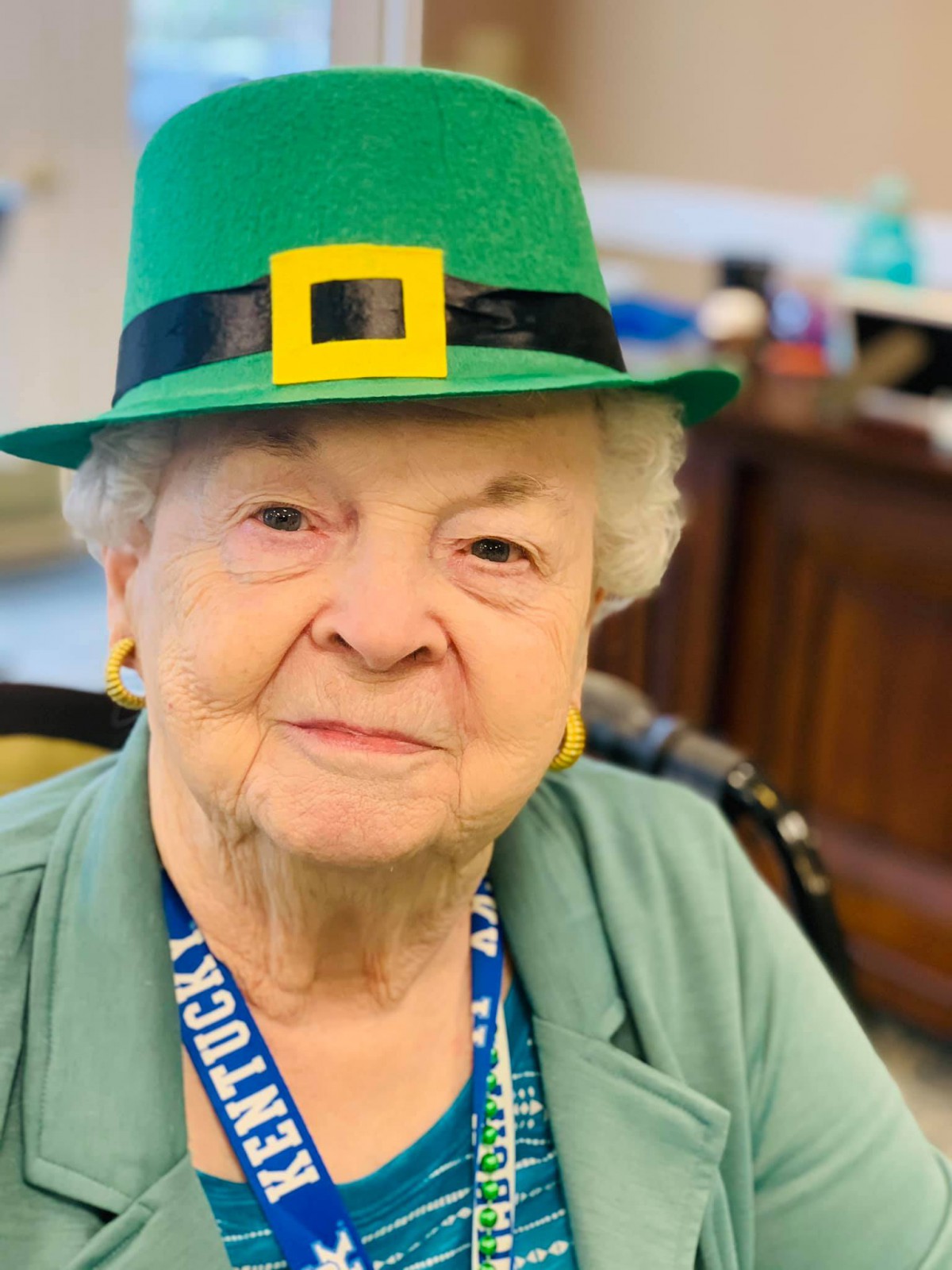 Elderly woman wearing a green St. Patrick's Day hat.