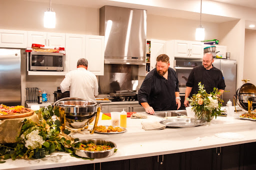 Chefs preparing a gourmet meal in a modern kitchen.