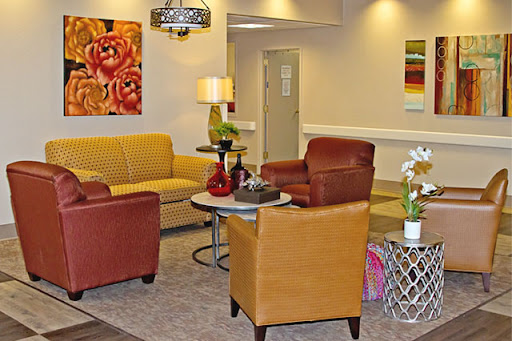A cozy lounge area featuring colorful seating, modern decor, and vibrant artwork.