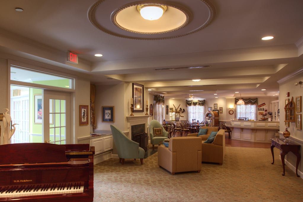 A cozy living room with comfortable seating and a piano.