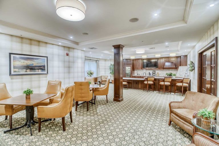 A modern dining area with comfortable seating and a bar.