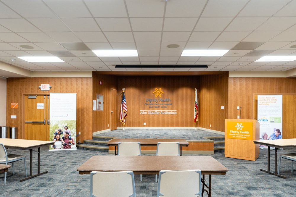 A conference room with a stage, podium, and seating arrangement.