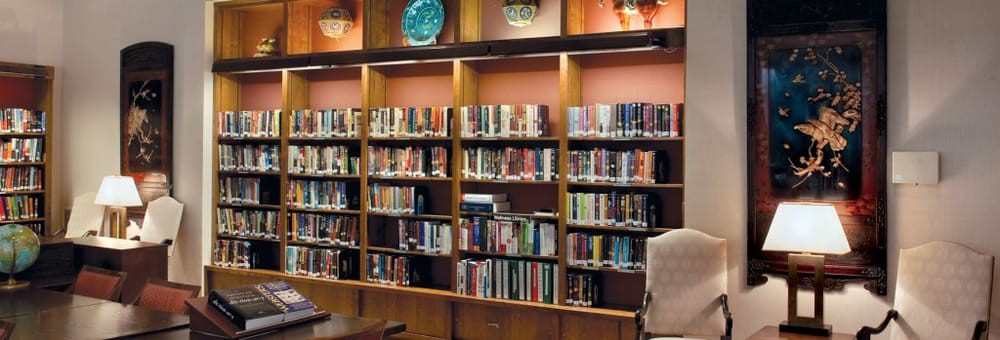 A cozy library interior featuring bookshelves filled with an array of books.
