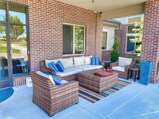 A cozy outdoor seating area featuring a comfortable sofa and chairs, perfect for relaxation.