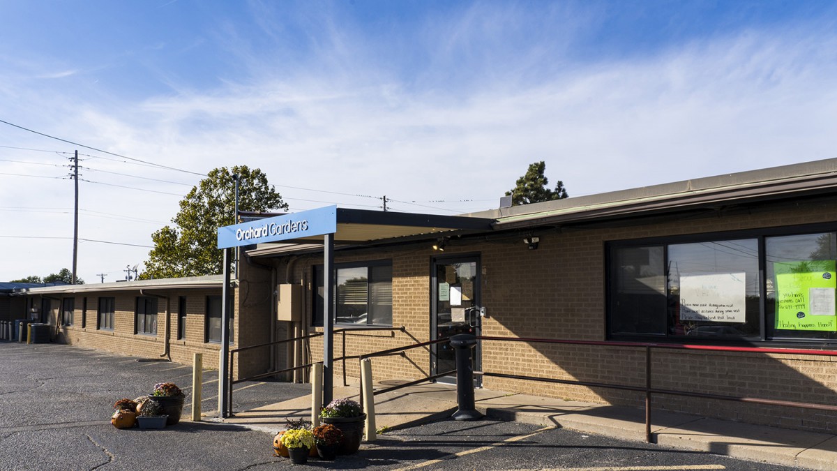 A clinic building with a visible entrance and clear skies overhead.