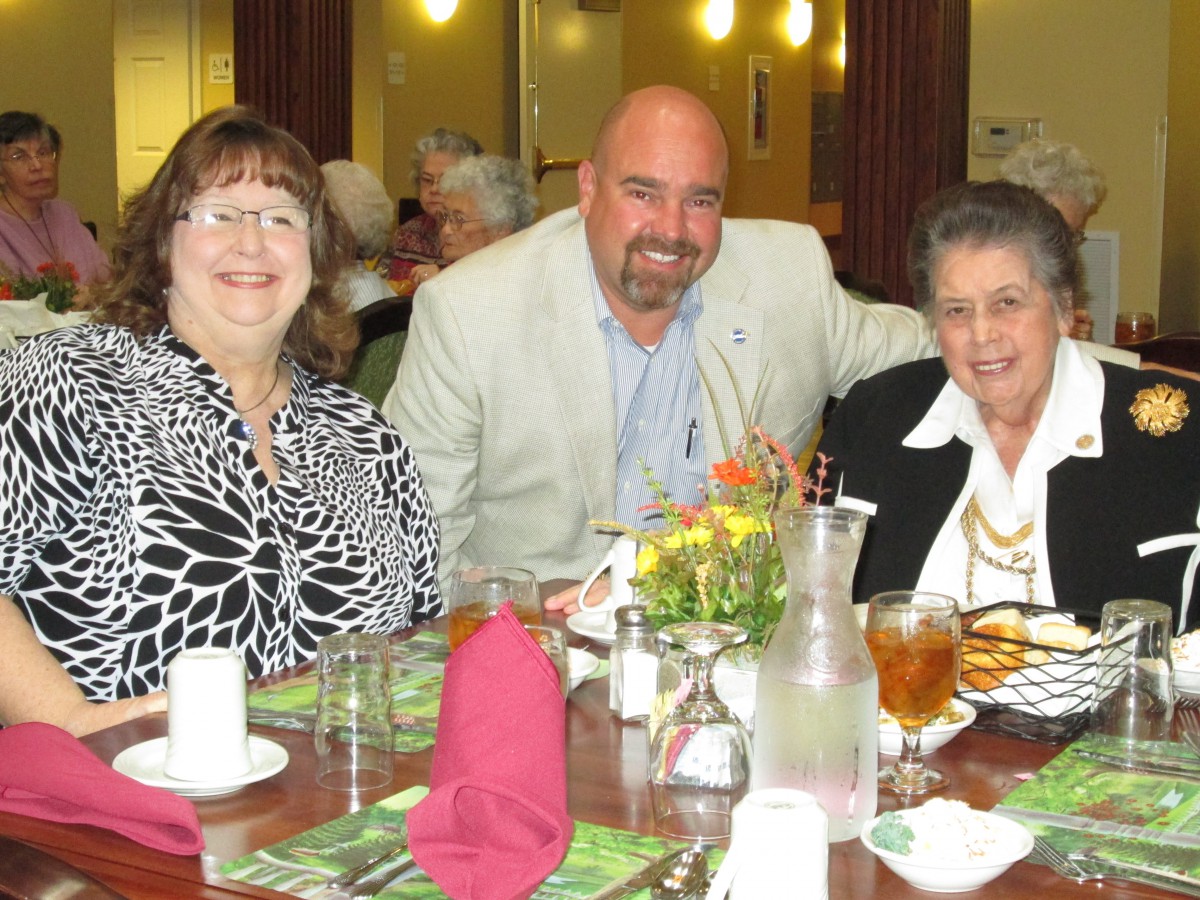 A group of three people enjoying a meal together at a restaurant.