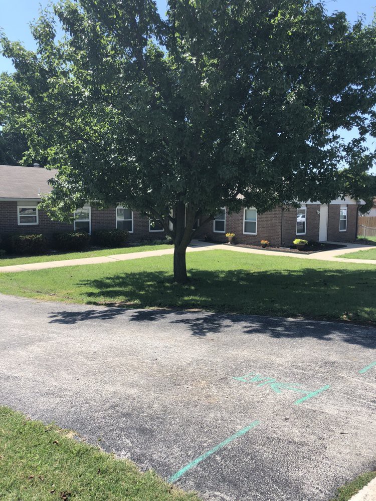 A tranquil courtyard with a large tree and surrounding buildings.