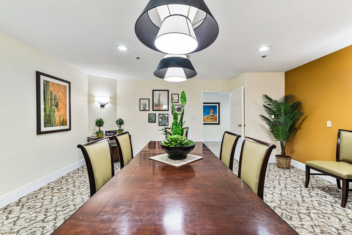 A stylish dining room with modern lighting and elegant furniture.