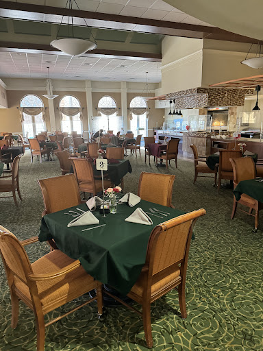 A spacious dining area featuring well-arranged tables and a welcoming atmosphere.