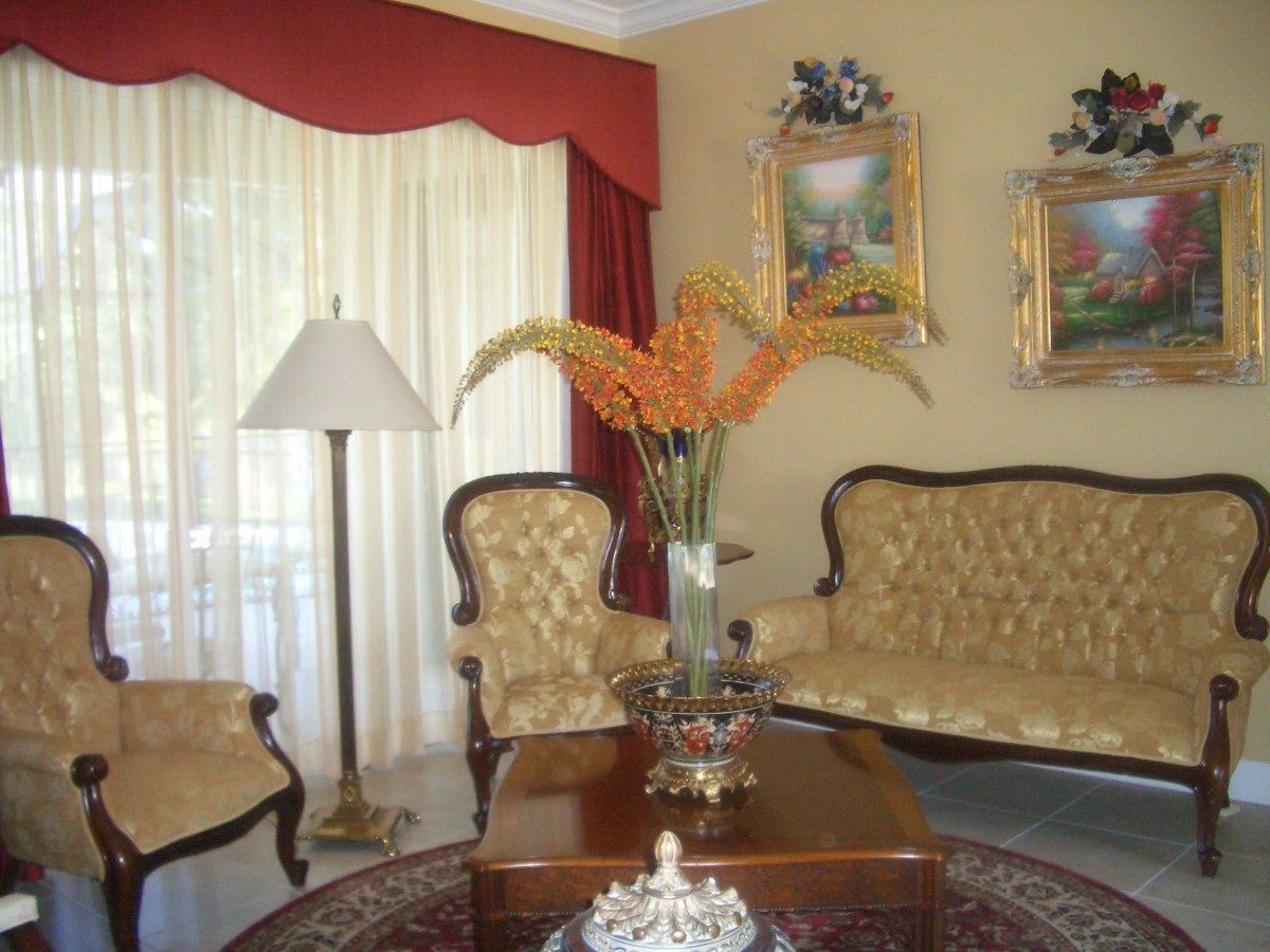 A traditionally decorated living room with elegant furniture and artwork.