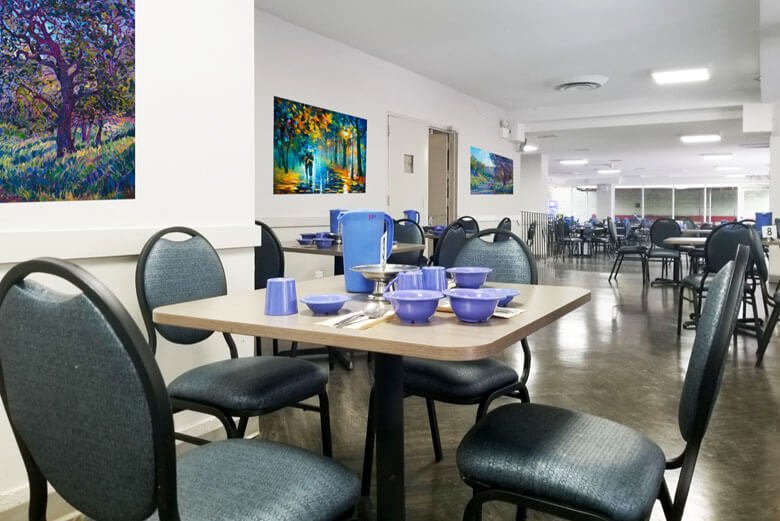 A neatly set dining area with tables and chairs, ready for guests.