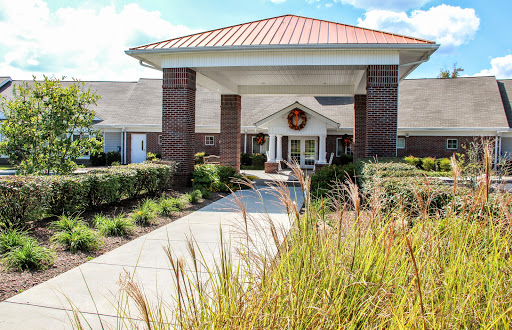 The inviting entrance of a community center, surrounded by well-maintained landscaping.