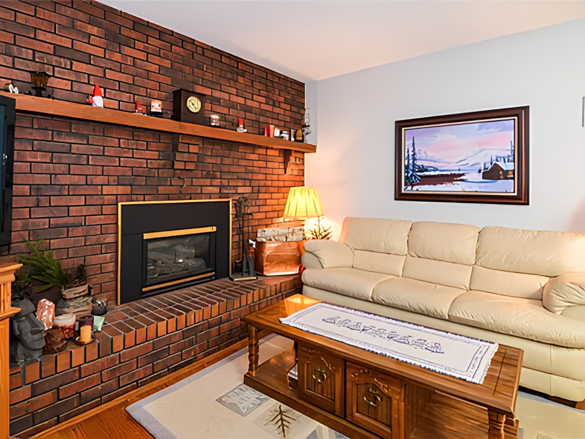 Cozy living room with a brick fireplace and comfortable seating.