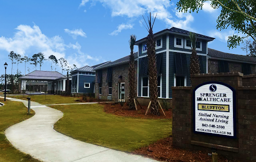 A modern residential building with well-maintained landscaping and clear signage.