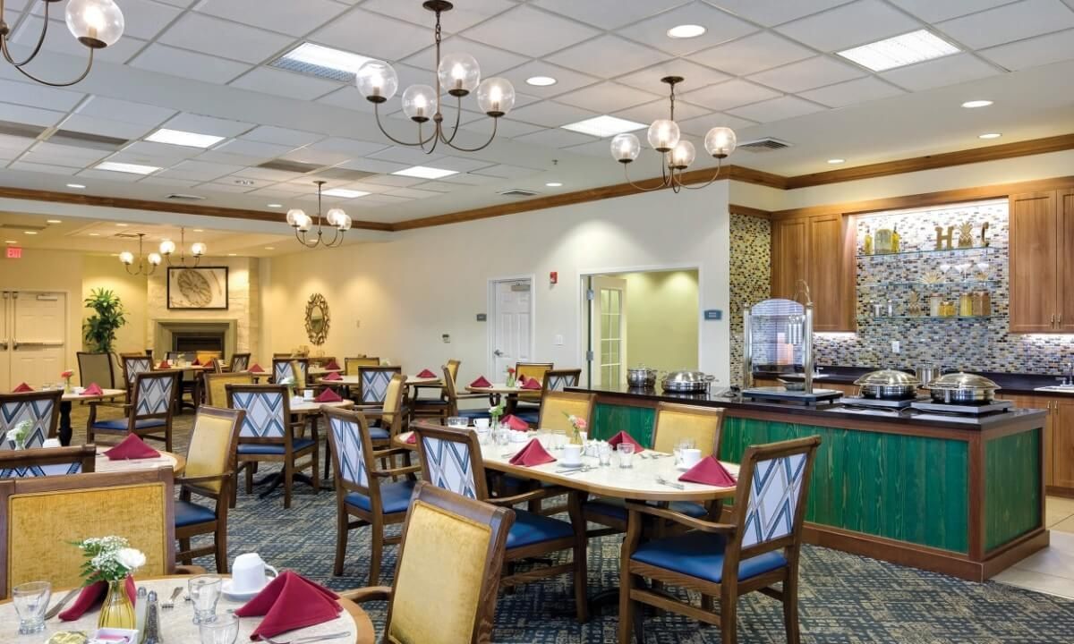An elegantly decorated dining room with neatly arranged tables and chairs.