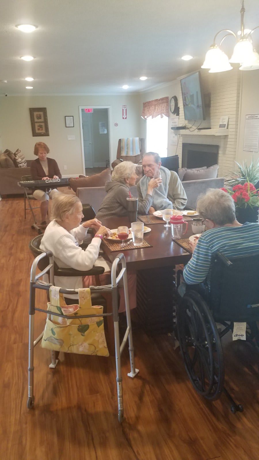 A group of seniors socializing and having a meal together in a communal setting.