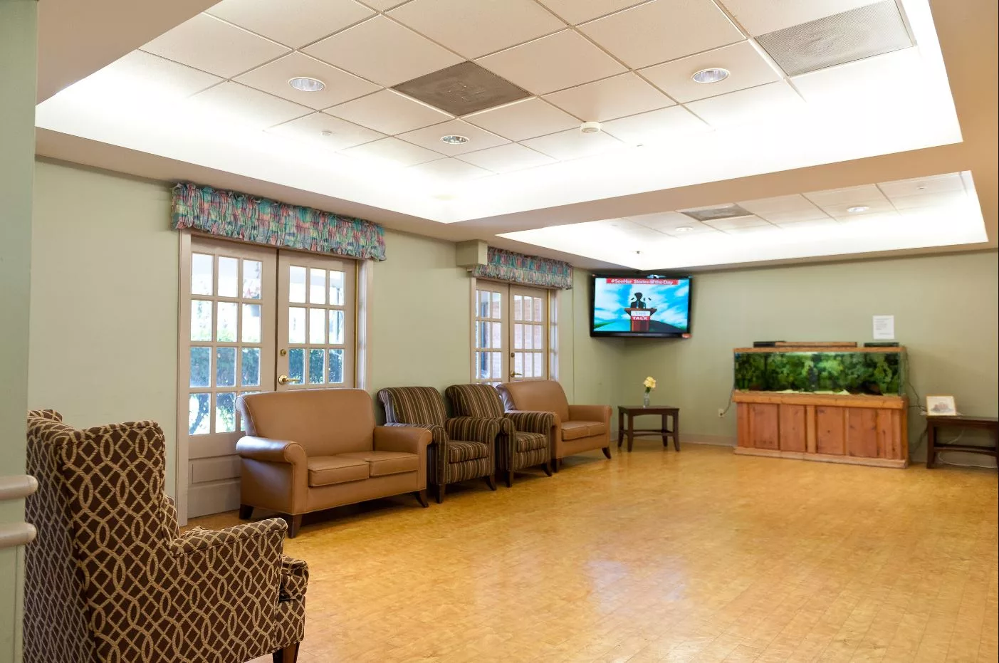 A comfortable indoor seating area with a television and fish tank.