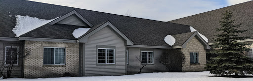 A cozy house covered in snow during winter.