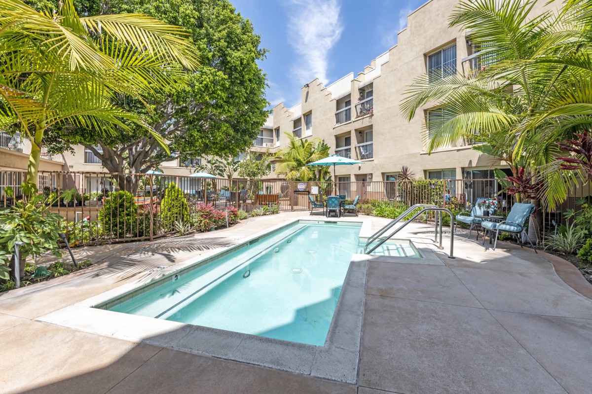 A sunny day by the pool in a modern apartment complex.