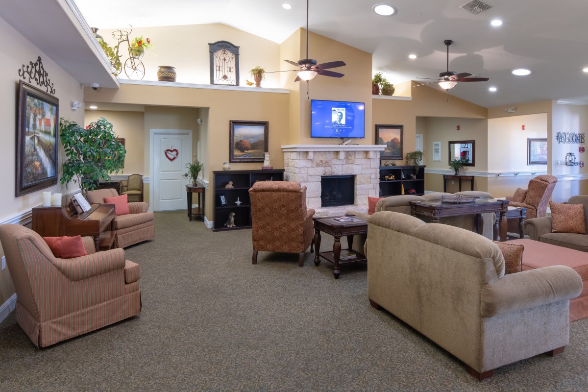 A cozy living room with comfortable seating, a television, and a fireplace.
